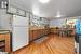 Kitchen with sink, light hardwood / wood-style flooring, decorative backsplash, white fridge, and beverage cooler