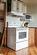 Kitchen featuring light hardwood / wood-style flooring and white appliances