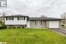 Split level home with a garage and a front yard