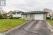 Split level home with a garage and a front yard