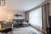 Living room featuring plenty of natural light and light hardwood / wood-style floors