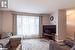 Living room with a textured ceiling and light hardwood / wood-style floors