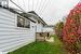 View of side of property with a deck and a yard