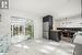 Kitchen with wooden counters, hanging light fixtures, and stainless steel fridge