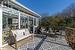 Wooden deck featuring an outdoor living space and a sunroom