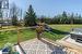 Wooden deck with a lawn and a hot tub