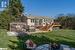 Back of property featuring a deck, a gazebo, a yard, and a fire pit