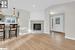 Living room with lofted ceiling, a wealth of natural light, a high end fireplace, and light hardwood / wood-style flooring