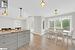 Kitchen with pendant lighting, plenty of natural light, light hardwood / wood-style floors, and vaulted ceiling