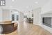 Living room featuring french doors, vaulted ceiling, a premium fireplace, and light hardwood / wood-style flooring