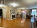 Living room with hardwood / wood-style floors, ornamental molding, and a textured ceiling