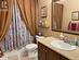 Full bathroom with toilet, vanity, tile patterned floors, and shower / bathtub combination with curtain