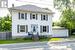 Colonial-style house with a garage and an outdoor structure