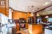 Kitchen featuring appliances with stainless steel finishes, dark stone counters, light tile patterned floors, pendant lighting, and a center island