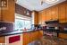 Kitchen featuring backsplash, sink, white dishwasher, and gas range