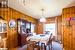 Carpeted dining space with wooden walls