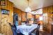 Dining room featuring tile patterned floors and wood walls