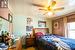 Carpeted bedroom featuring ceiling fan and ornamental molding