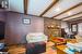 Living room with a fireplace, hardwood / wood-style floors, beamed ceiling, and crown molding