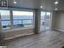 Foyer featuring light hardwood / wood-style floors, vaulted ceiling, and a wall mounted AC