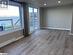 Kitchen with a wall mounted AC, a kitchen island with sink, sink, and light wood-type flooring