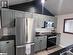 Kitchen with pendant lighting, light wood-type flooring, stainless steel appliances, and sink