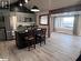 Kitchen with a kitchen bar, appliances with stainless steel finishes, sink, decorative light fixtures, and hardwood / wood-style floors