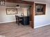 Empty room featuring baseboard heating and dark wood-type flooring