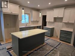 Kitchen with ivory and jade cabinets, granite countertops. -