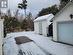 Snowy yard featuring an outdoor structure and a garage