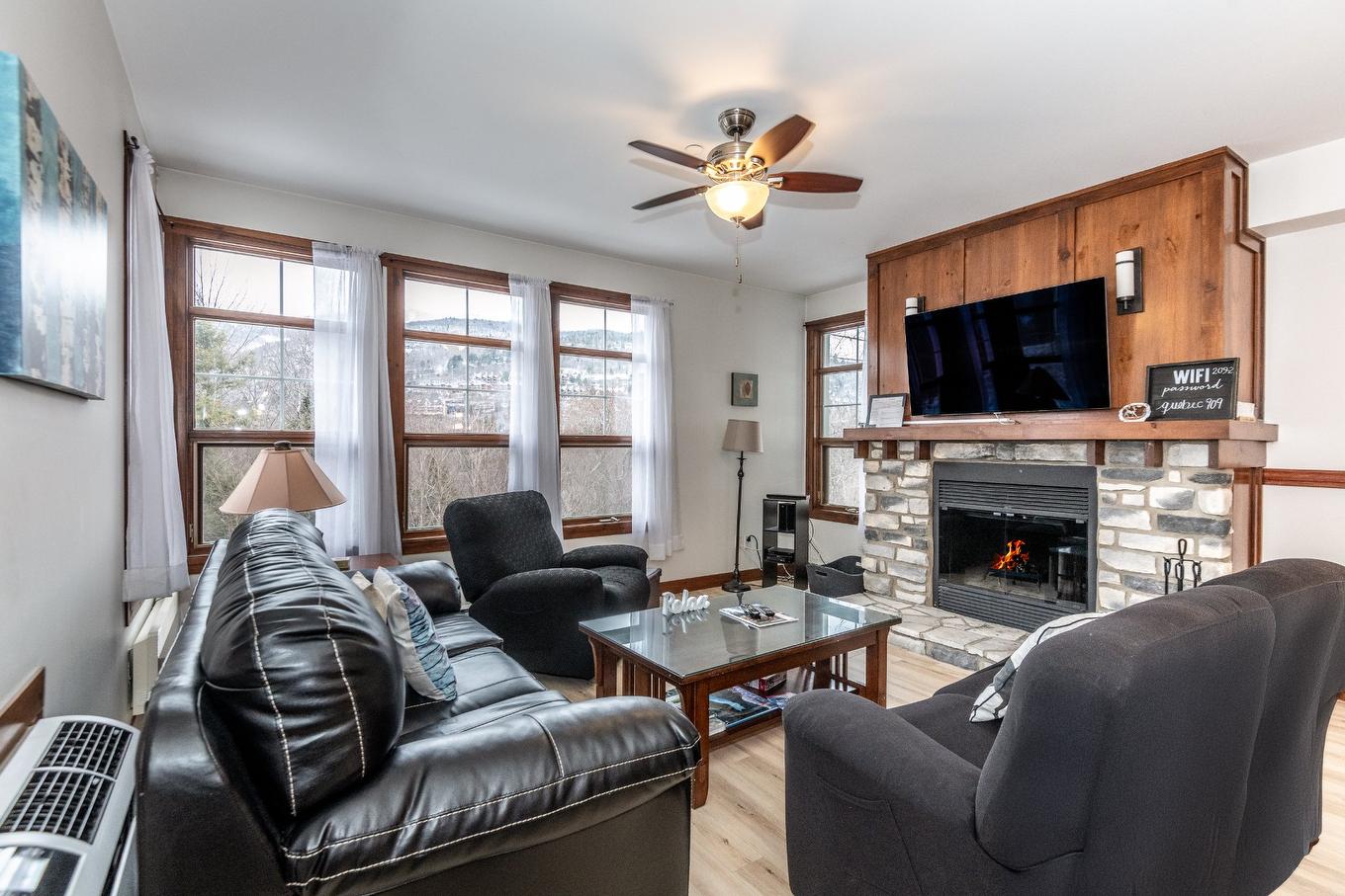 Living room - 2-209 Ch. Des Quatre-Sommets, Mont-Tremblant, QC - Indoor Photo Showing Living Room With Fireplace