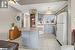 Kitchen with kitchen peninsula, a breakfast bar, white appliances, sink, and decorative light fixtures