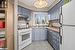 Kitchen featuring light tile patterned flooring, white appliances, and sink