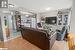 Living room with light wood-type flooring and a textured ceiling