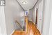 Hallway featuring a textured ceiling and light hardwood / wood-style floors