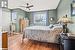 Bedroom with ceiling fan and hardwood / wood-style floors