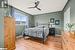 Bedroom with ceiling fan and light wood-type flooring