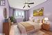 Bedroom featuring ceiling fan, light wood-type flooring, and a textured ceiling