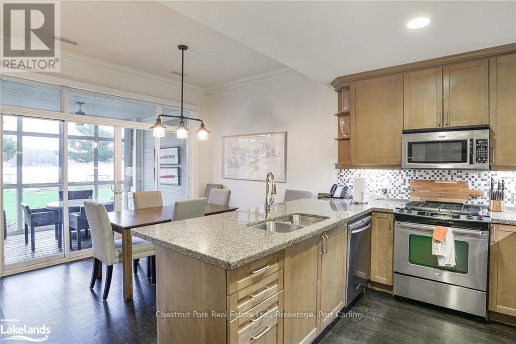 G103-A1 - 1869 Muskoka 118 Road W, Muskoka Lakes (Monck (Muskoka Lakes)), ON - Indoor Photo Showing Kitchen With Double Sink With Upgraded Kitchen