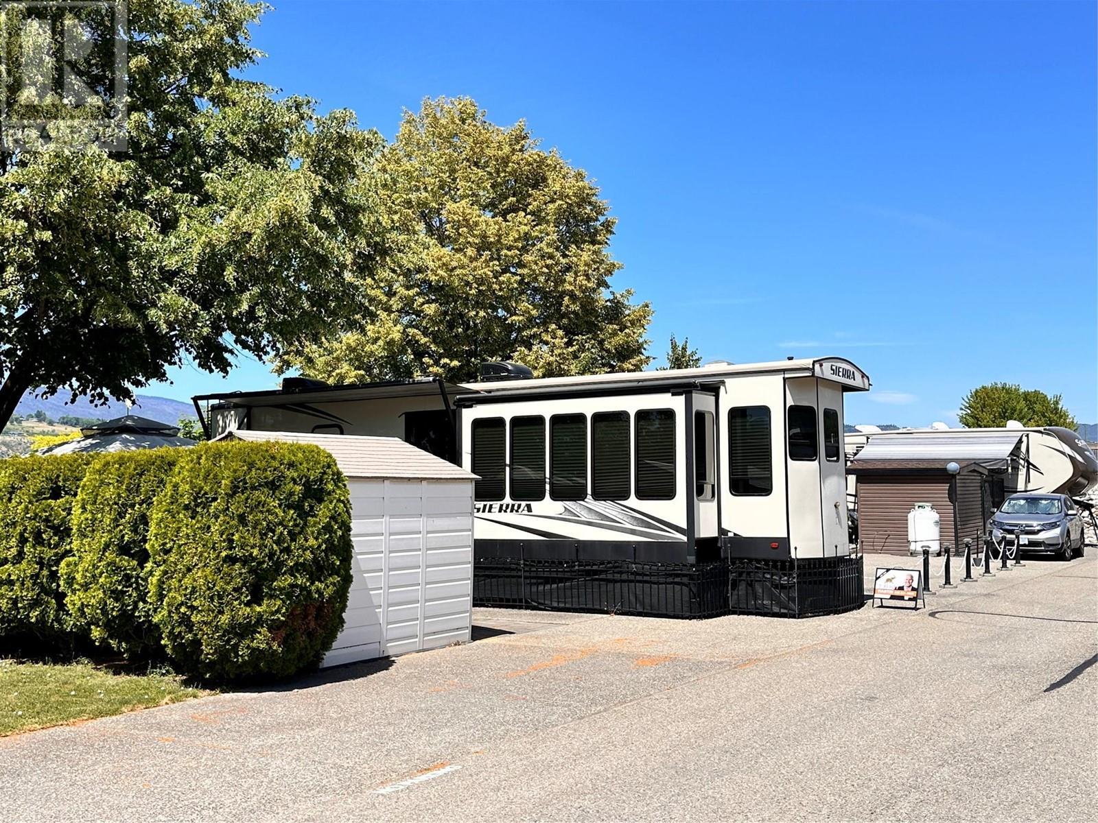 View across the front towards the pool - 8000 Highland Road Unit# 31, Vernon, BC