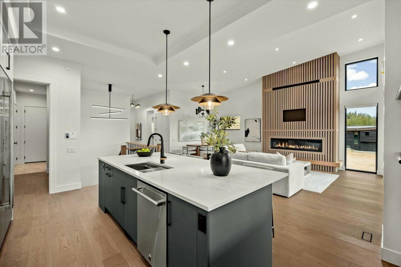 124 Wildsong Crescent W, Vernon, BC - Indoor Photo Showing Kitchen With Fireplace With Upgraded Kitchen