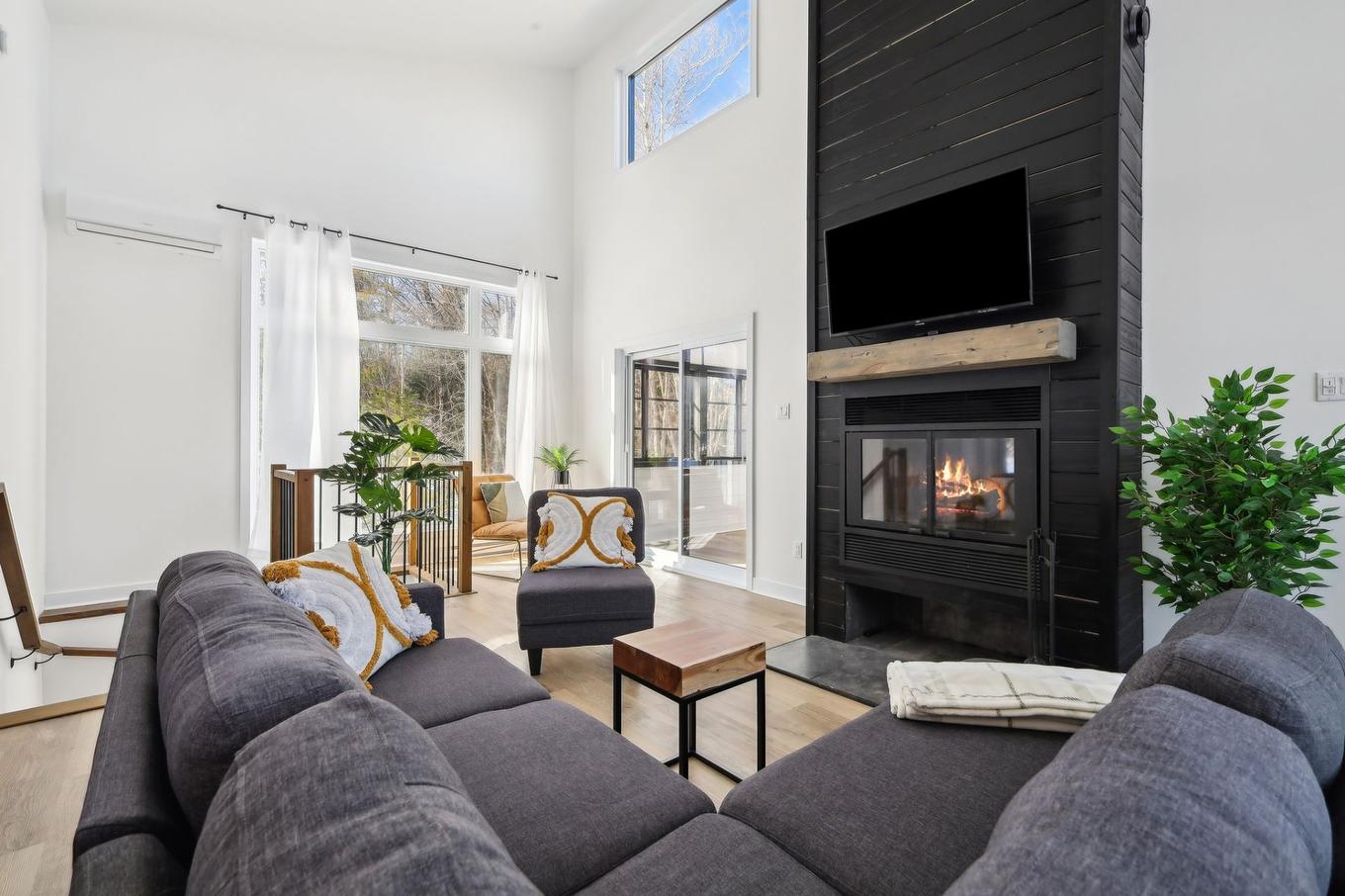 Living room - 25 Ch. Des Cerisiers, Lac-Supérieur, QC - Indoor Photo Showing Living Room With Fireplace