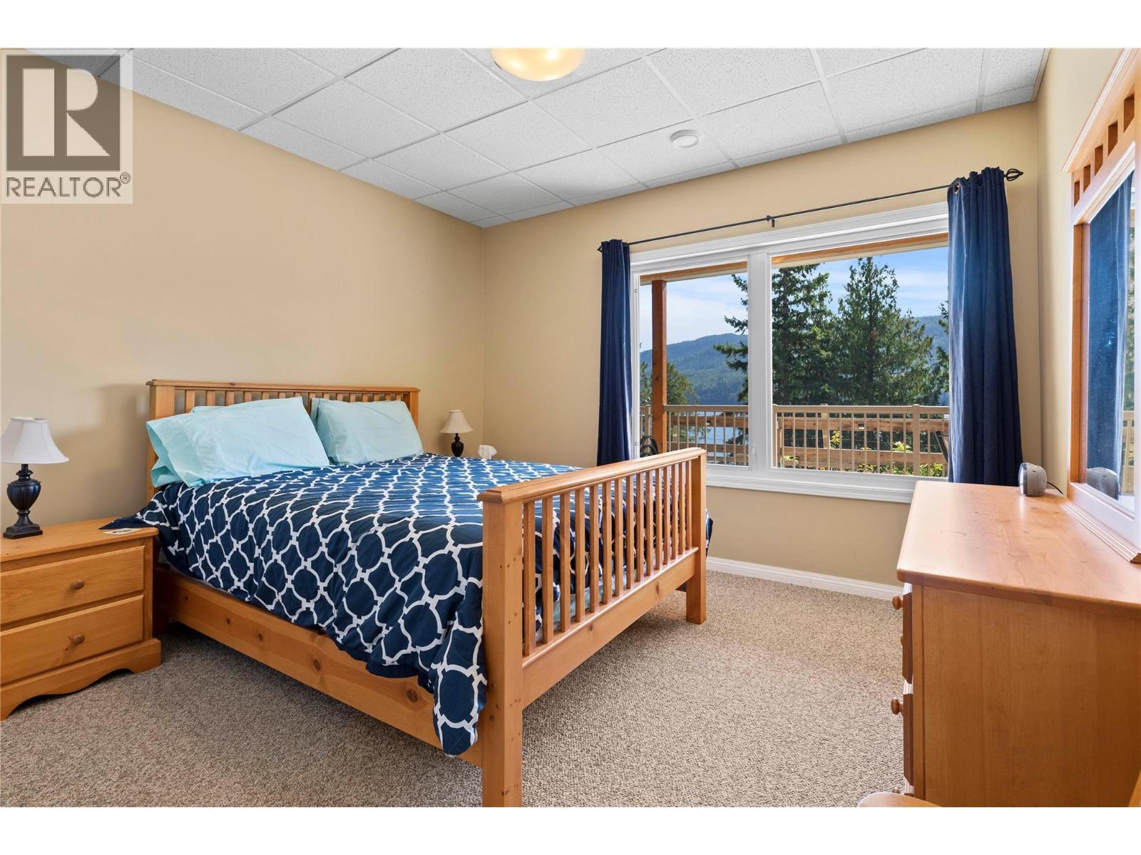 Suite 1st Bedroom with lake view - 8738 Squilax Anglemont Road, St. Ives, BC - Indoor Photo Showing Bedroom