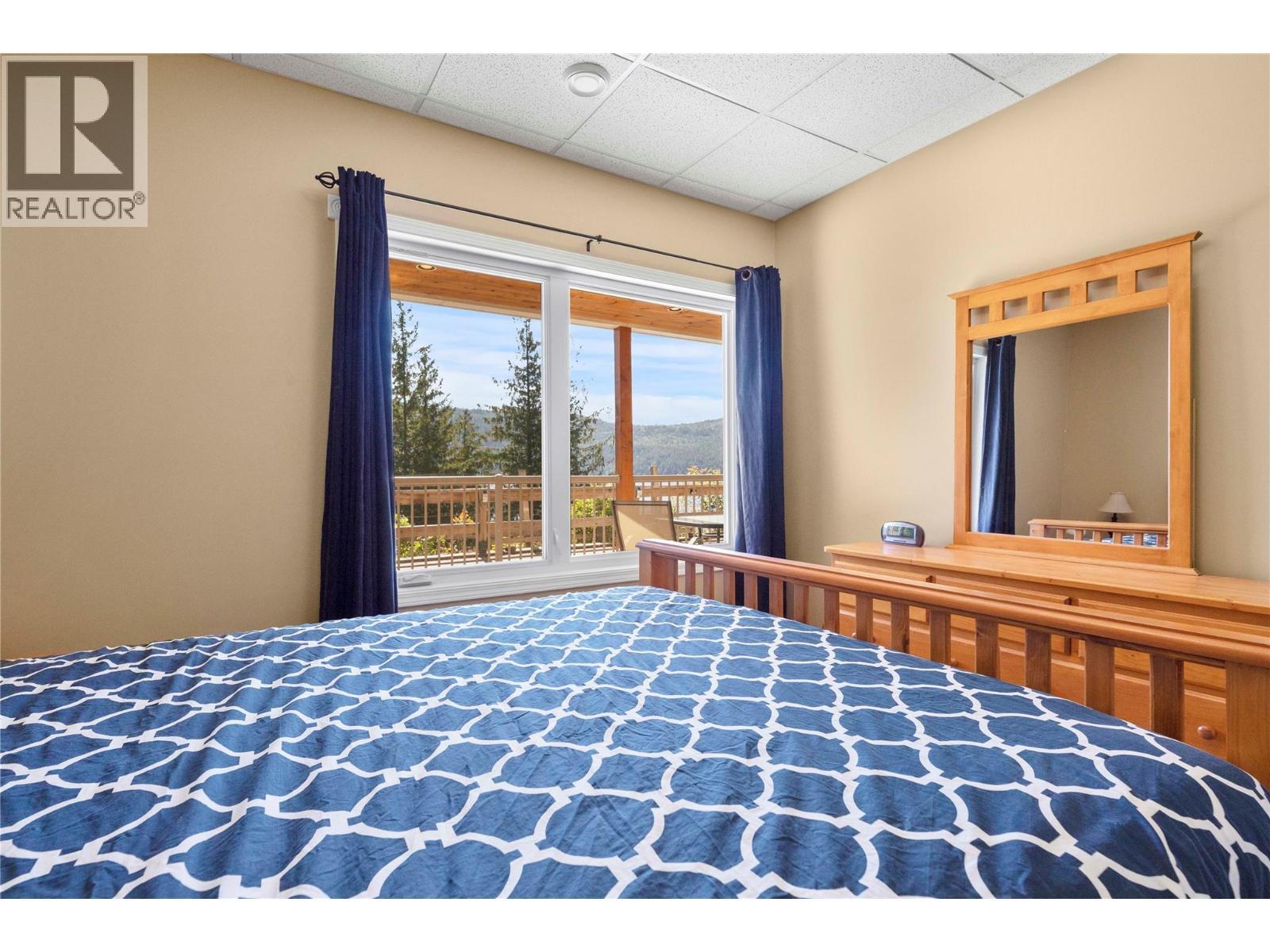 Suite 1st Bedroom with lake view - 8738 Squilax Anglemont Road, St. Ives, BC - Indoor Photo Showing Bedroom