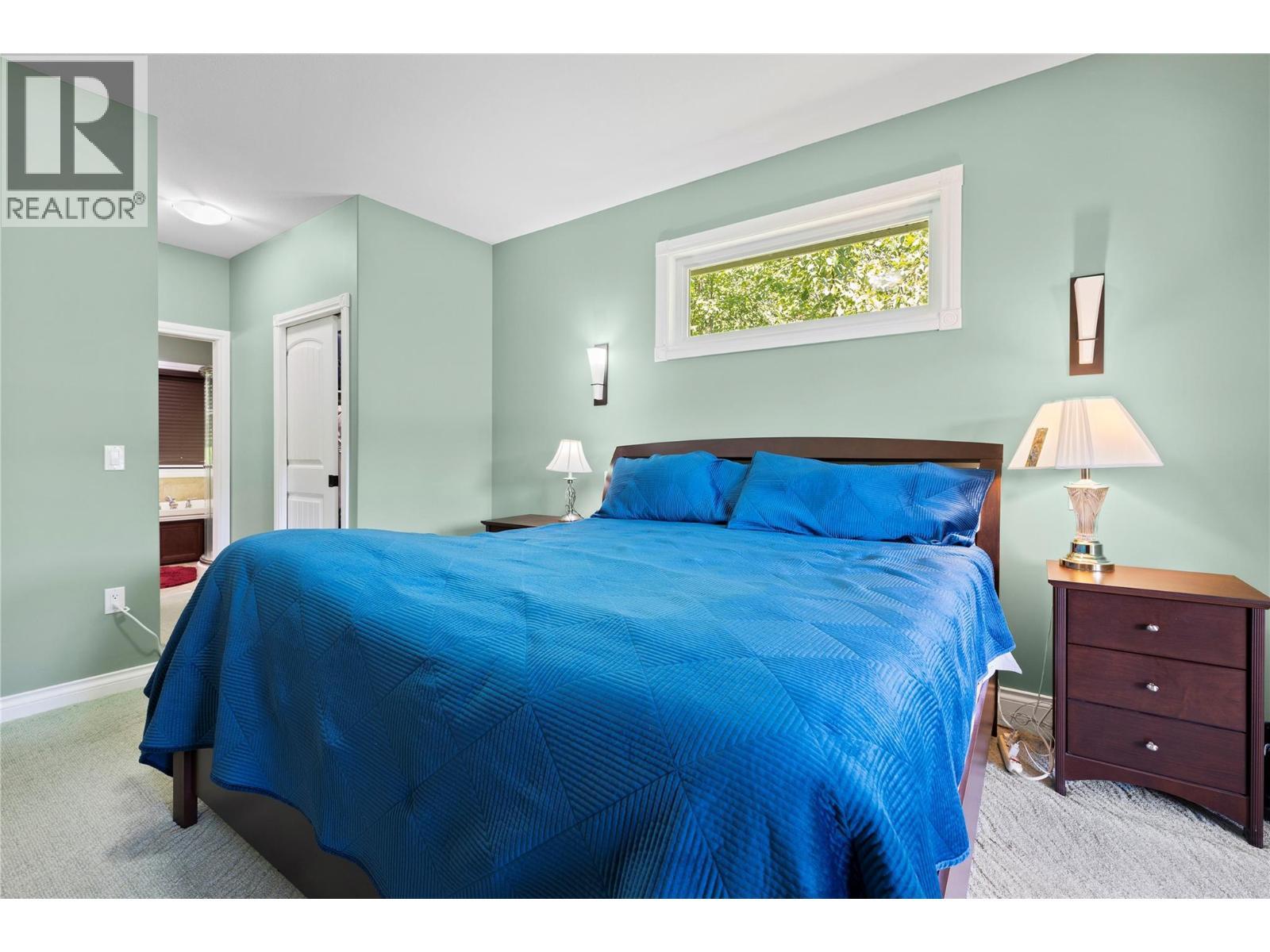 Primary Bedroom with a lake view - 8738 Squilax Anglemont Road, St. Ives, BC - Indoor Photo Showing Bedroom