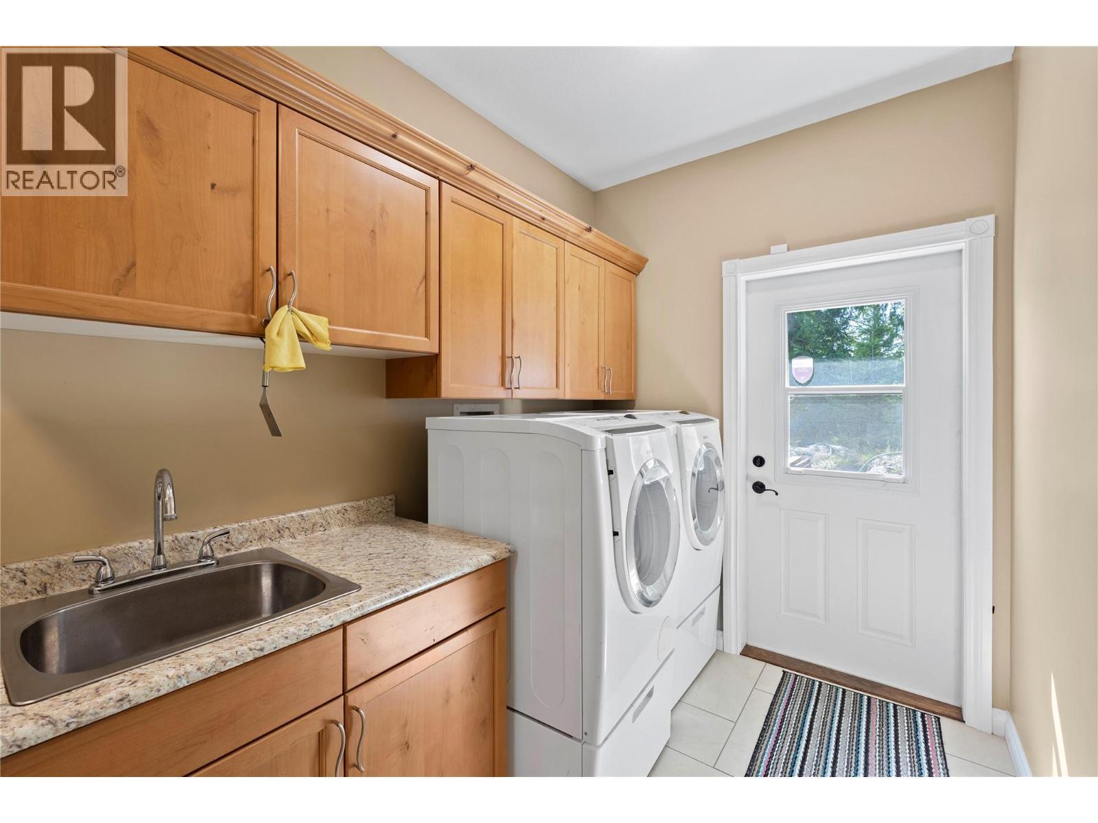 Laundry with exterior entry - 8738 Squilax Anglemont Road, St. Ives, BC - Indoor Photo Showing Laundry Room