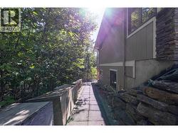 Path on East side of house to bsmt suite -