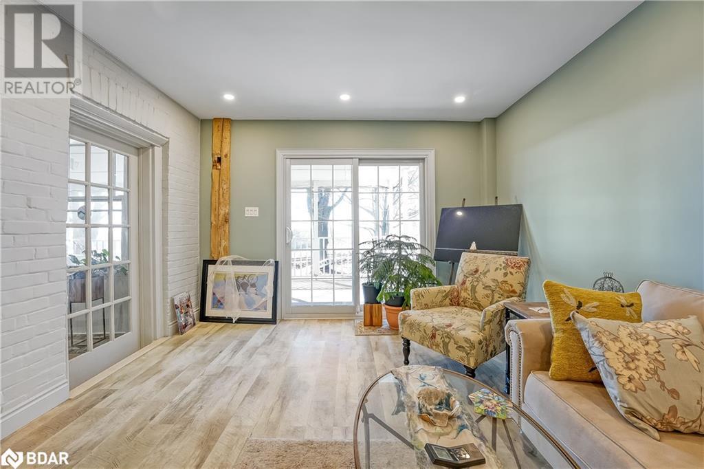 Living area with brick wall, recessed lighting, and wood finished floors - 7369 5Th Sideroad Side Road, Adjala-Tosorontio, ON