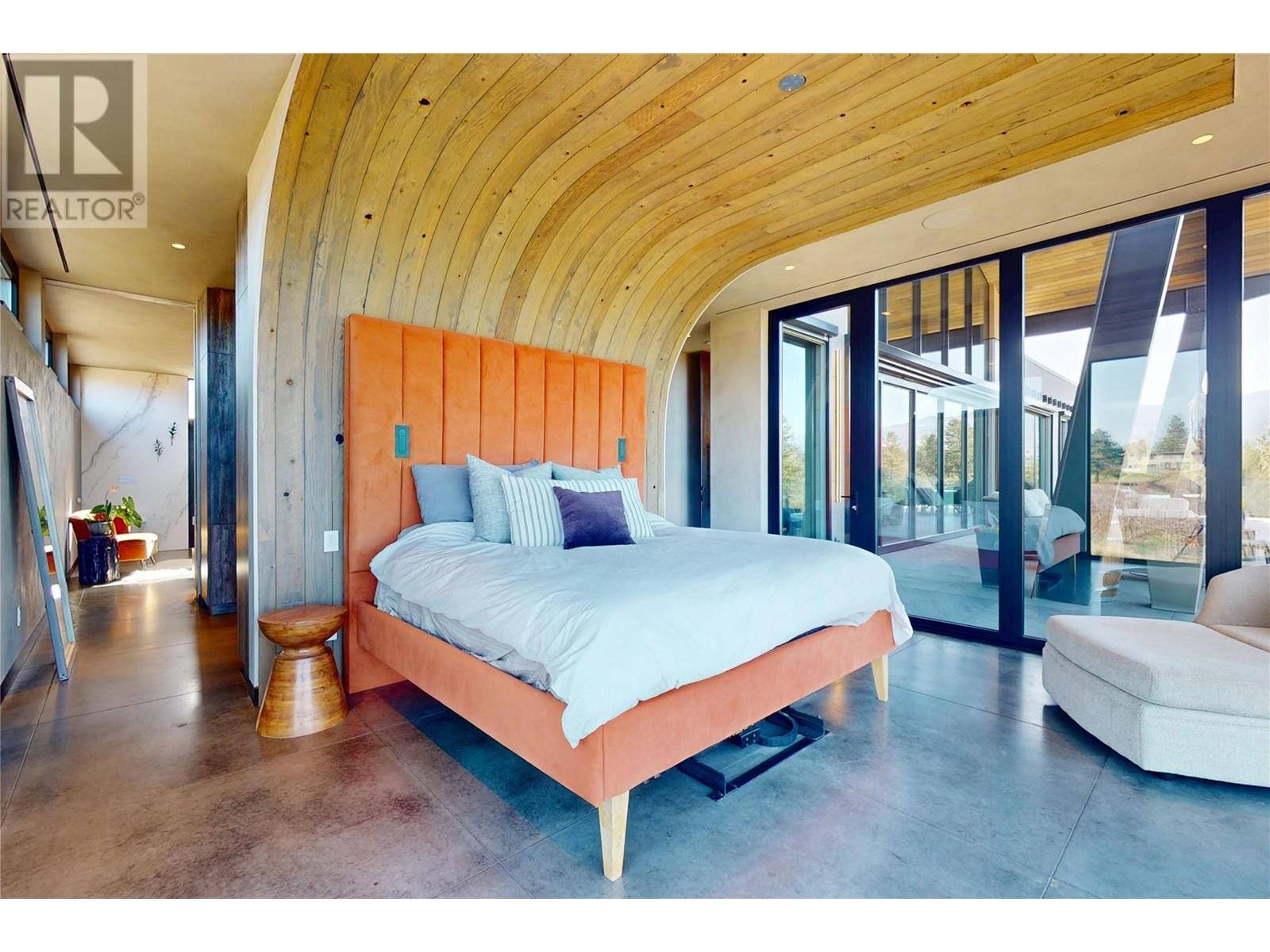 Primary Bedroom with Hemlock Wood arch feature - 4275 Todd Road, Kelowna, BC - Indoor Photo Showing Bedroom