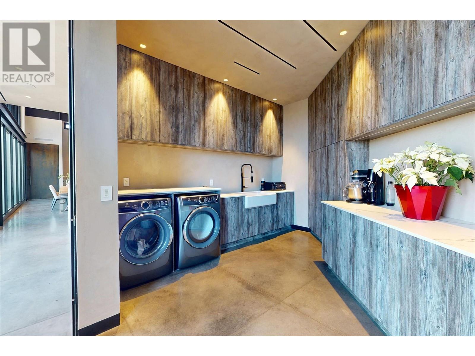 Loads and loads of storage space - 4275 Todd Road, Kelowna, BC - Indoor Photo Showing Laundry Room